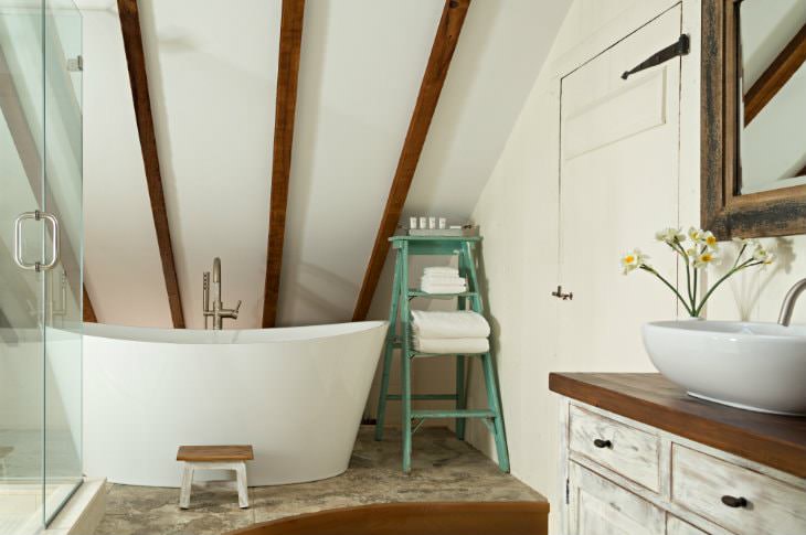 Vaulted white bathroom with walk-in shower with glass doors, rustic vanity with modern white sink and modern freestanding tub